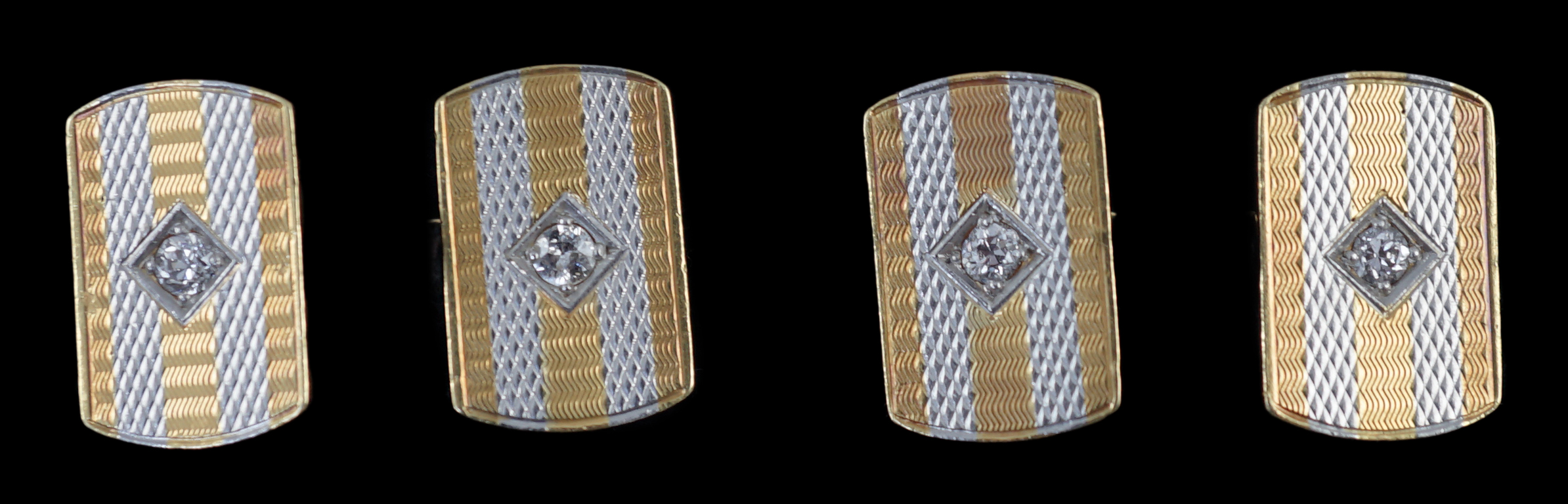 A pair of mid 20th century two colour 18ct gold and single stone diamond set cufflinks